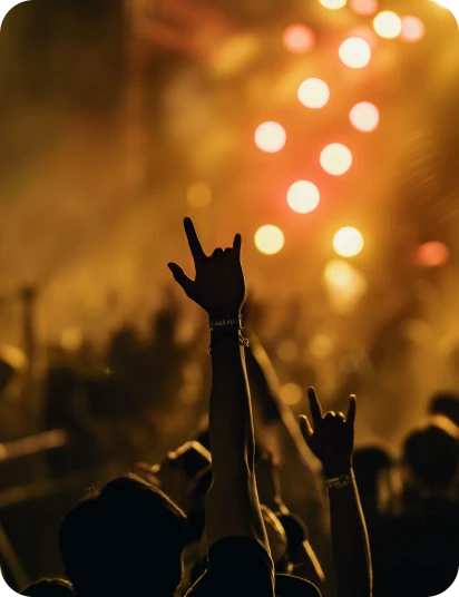 Audience at a concert under warm orange lights